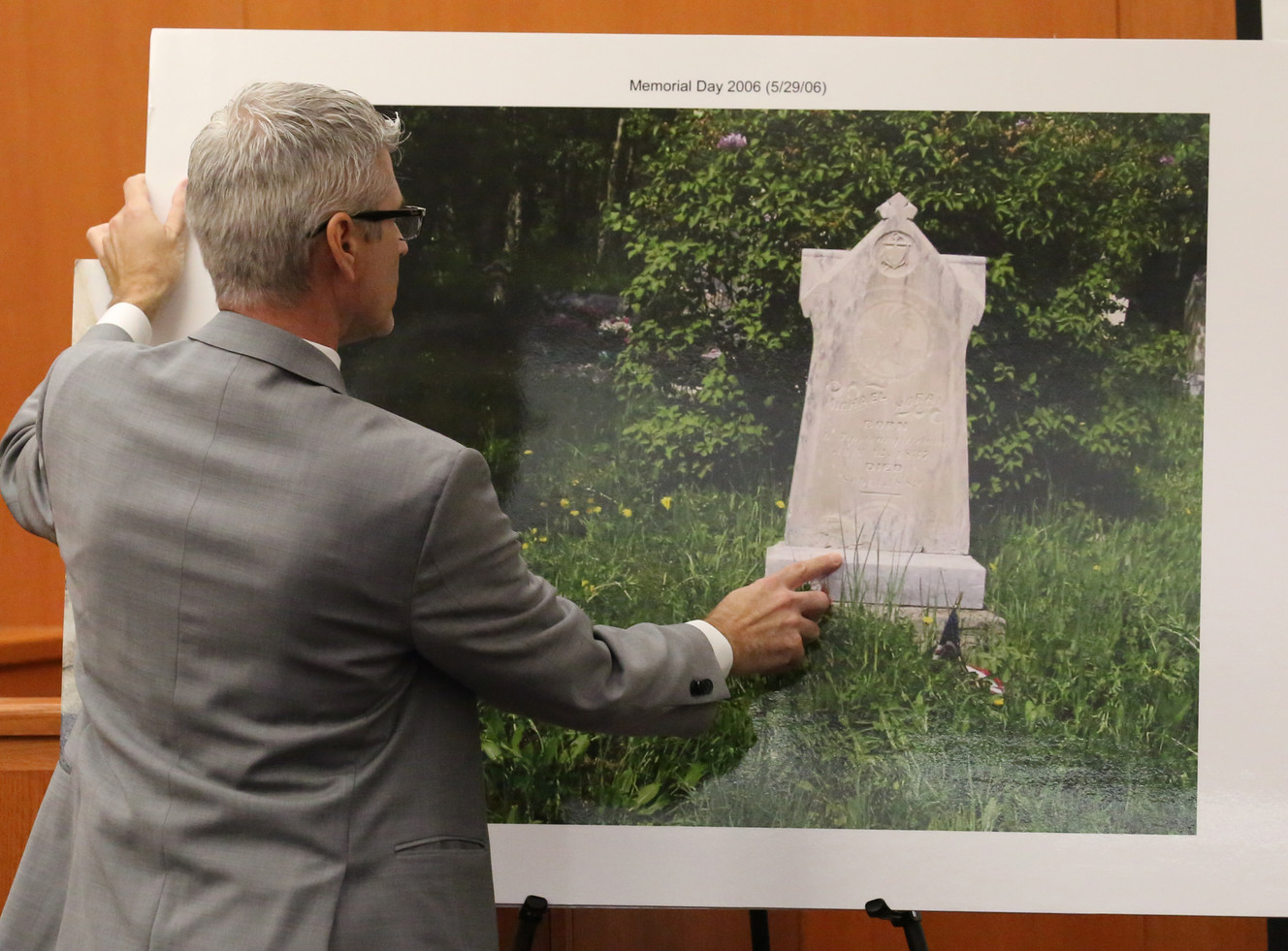 Lawyer for Glenwood Cemetery Association Paul Belnap holds a photo showing the headstone that killed a 4-year-old boy during court Tuesday, Oct. 27, 2015, in Park City. Lawyers for the family of a 4-year-old Utah boy crushed by a tombstone say he died after shoddy maintenance left the historic headstone weak and dangerous. A trial began Tuesday in the lawsuit filed by the parents of Carson Dean Cheney of Lehi against the cemetery association in Park City. (Photo: Rick Bowmer)