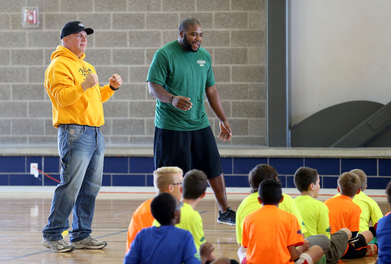 Garth Brooks and former NFL and BYU player Daniel Coats works with kids as the Garth Brooks Teammates for Kids Foundation and ProCamps team up to put on a clinic for underprivileged children, Saturday, Oct. 31, 2015, in Salt Lake City. (Photo: Tom Smart, Deseret News)