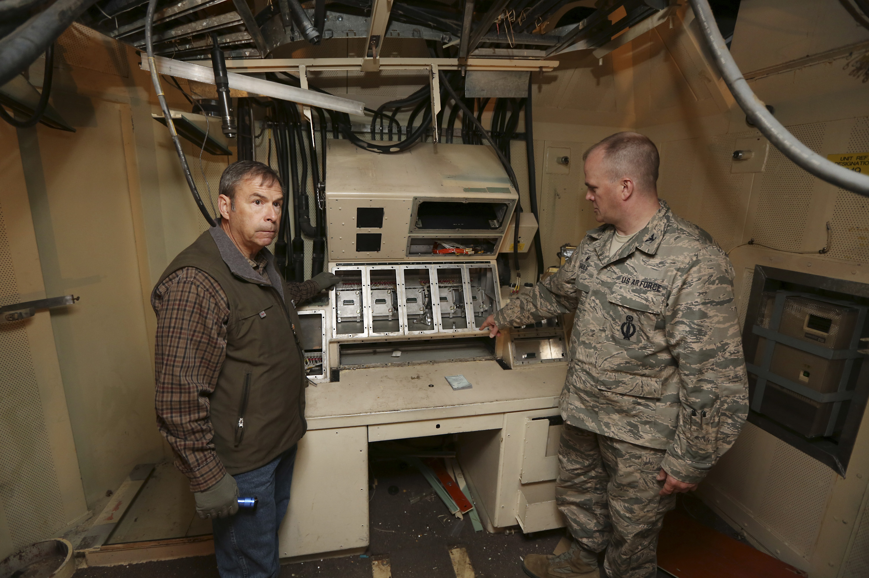 FILE - In this April 6, 2015 file photo, retired Air Force Col. Barry Kistler, left, and Col. Todd Sauls stand at a former control panel in the underground launch control center at the Air Force's Quebec-01 Missile Alert Facility. Photo: AP Photo