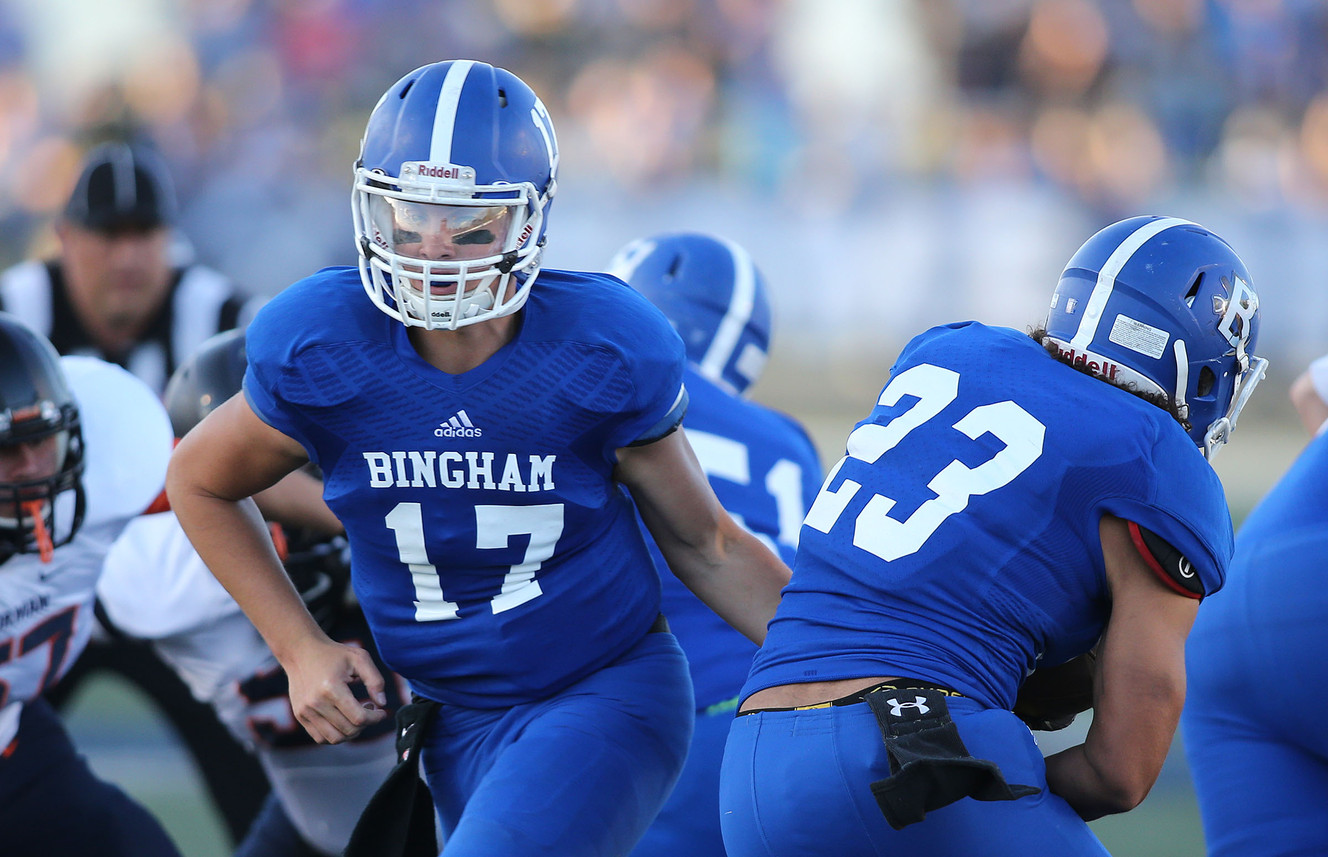 Bingham quarterback Keaton Torre hands off to Jahvontay Smith as Bingham High School plays Bishop Gorman High School (Nev.) the consensus top-ranked program in football program in America, Sept. 4, 2015, in South Jordan. (Photo: Tom Smart, Deseret News)