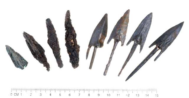 Lead sling stones and Bronze arrowheads stamped with the symbol of the reign of Antiochus Epiphanes. (Photo: Clara Amit/Courtesy Israel Antiquities Authority)