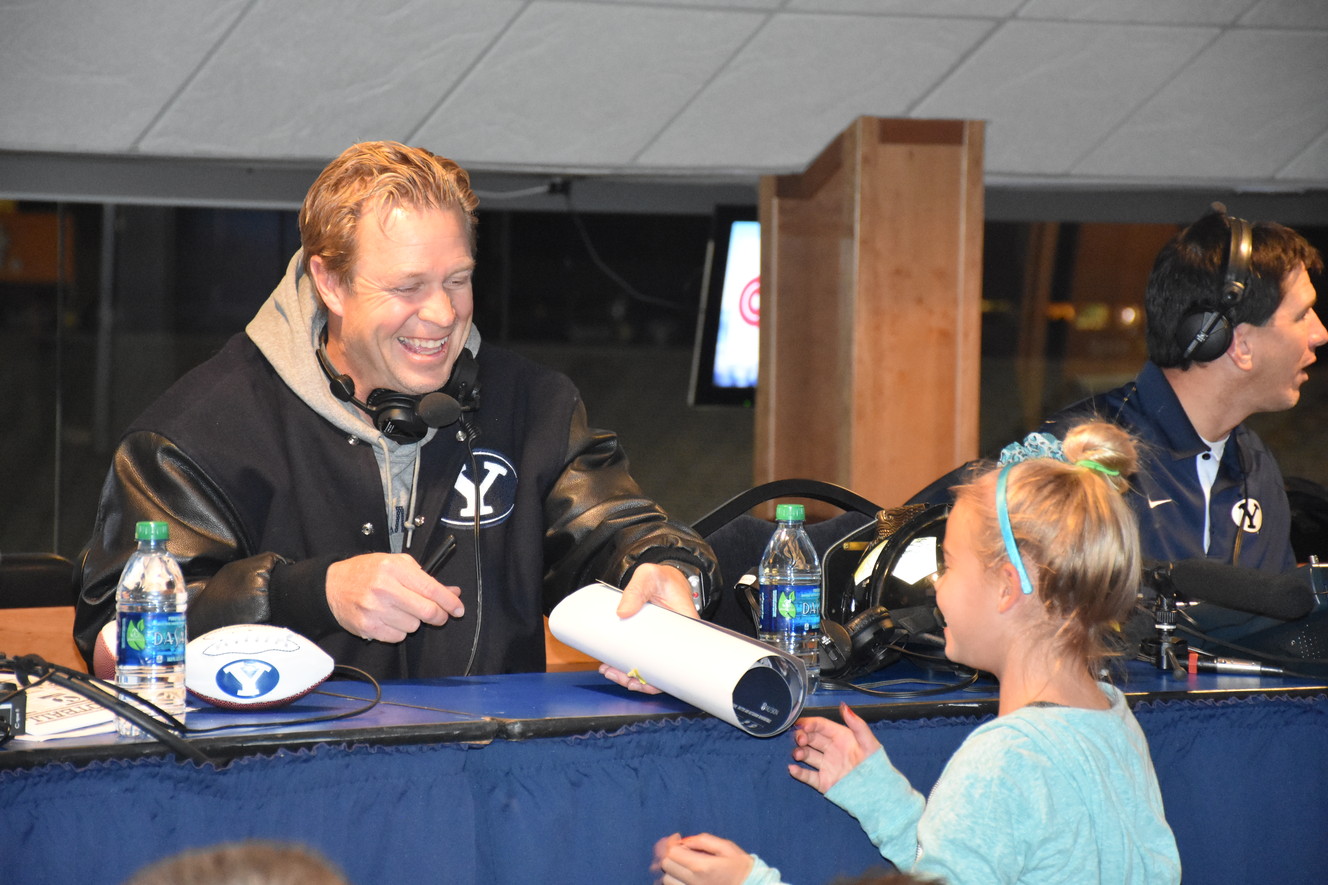 BYU football coach Bronco Mendenhall signs a poster for a young fan during Tuesday night's "BYU Football with Bronco Mendenhall" show on KSL NewsRadio. (Photo: Elora Grant, IMG)