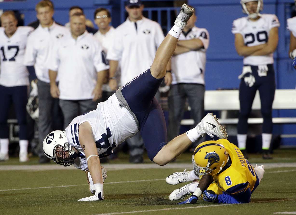 BYU's Remington Peck, left, leaps over San Jose State cornerback Jimmy Pruitt (8) after a catch during the first half of an NCAA college football game Friday, Nov. 6, 2015, in San Jose, Calif. (AP Photo/Marcio Jose Sanchez)