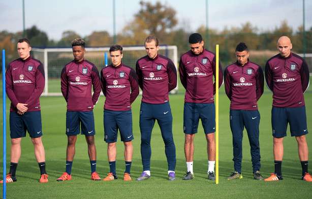 England national soccer team players observe a silence as a mark of respect to the victims of the terror attacks in Paris during a training session at Enfield Training Centre, London Monday Nov. 16, 2015. England will play against France at Wembley Stadium on Tuesday. (John Walton/PA via AP) UNITED KINGDOM OUT