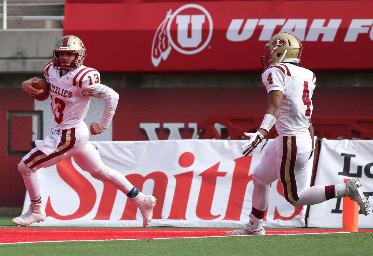 Logan quarterback Hunter Horsley runs 82 yards to score a touchdown with Hartman Rector right behind him during the 3AA state championship football game against Dixie at the Rice-Eccles Stadium in Salt Lake City on Friday, Nov. 20, 2015. (Photo: Kristin Murphy, Deseret News)
