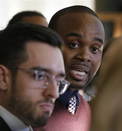 Journalist Brandon Smith, left, and activist William Calloway talk to reporters Thursday, Nov. 19, 2015, after a Cook County judge ordered the Chicago Police Department to release a video of an officer fatally shooting 17-year-old Laquan McDonald by Nov. 25, in Chicago. The video is said to show the officer shooting McDonald 16 times in October 2014. (AP Photo/Charles Rex Arbogast)