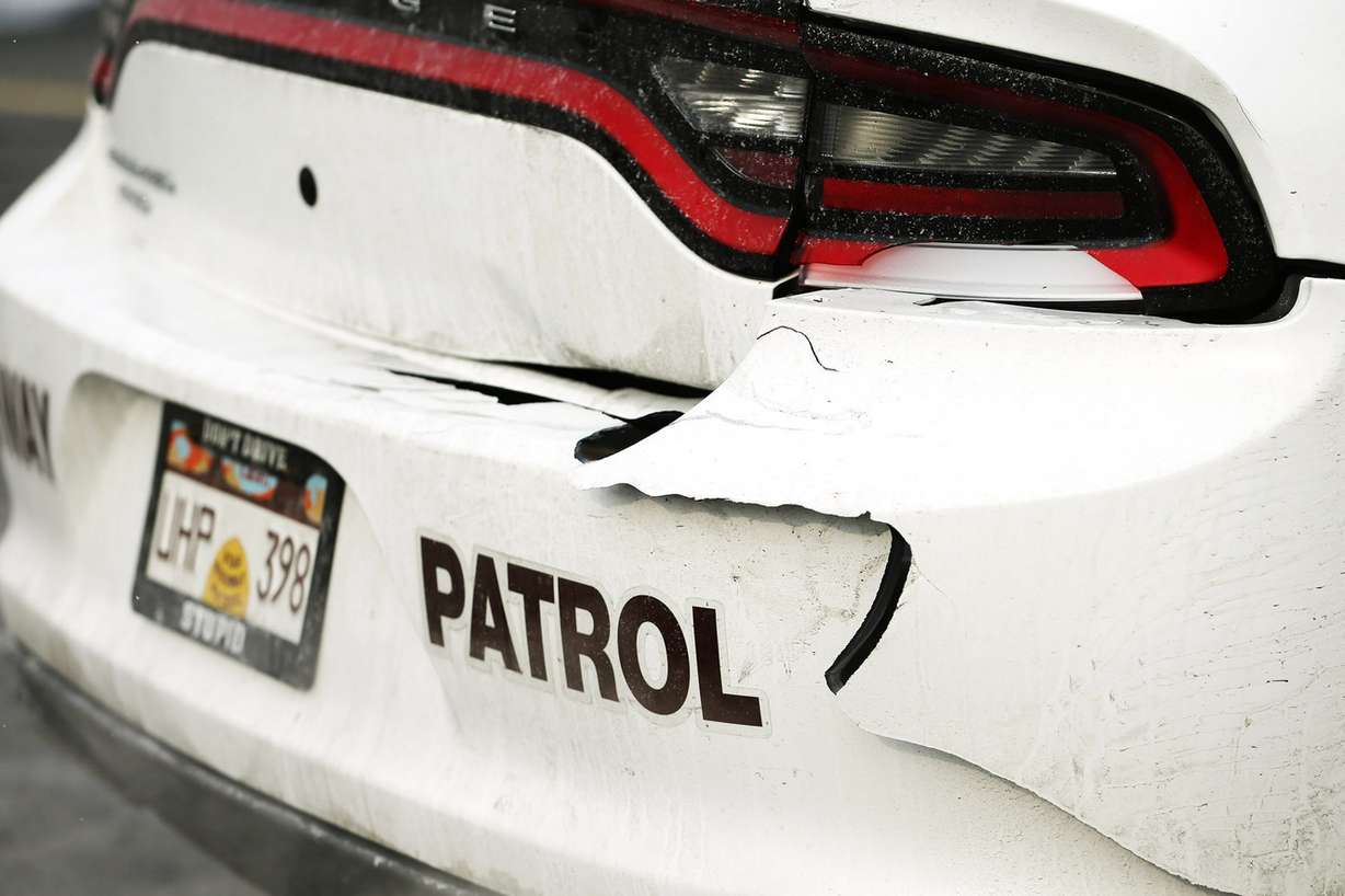 Damage to Utah Highway Patrol trooper Andy Battenfield's car is shown Sunday, Nov. 29, 2015. Battenfield's vehicle was hit by an SUV on I-15 over the weekend, and he talked about the need for safety on the roads. (Photo: Scott G Winterton, Deseret News)