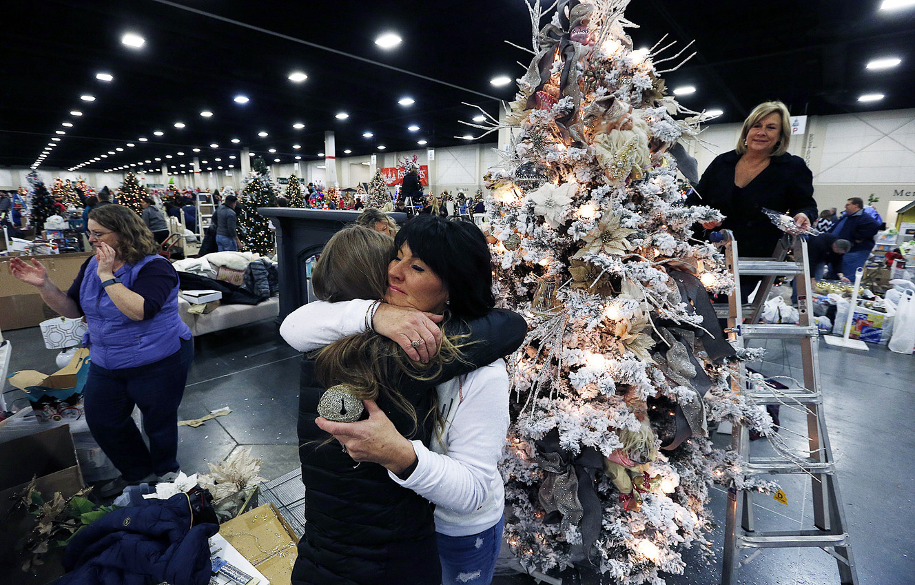 Heidi Miller hugs her daughter Sabrina as they decorate a tree in honor of Sherry Black, Heidi Miller's mother, for the Festival of Trees in Sandy on Monday, Nov. 30, 2015. (Photo: Ravell Call, Deseret News)