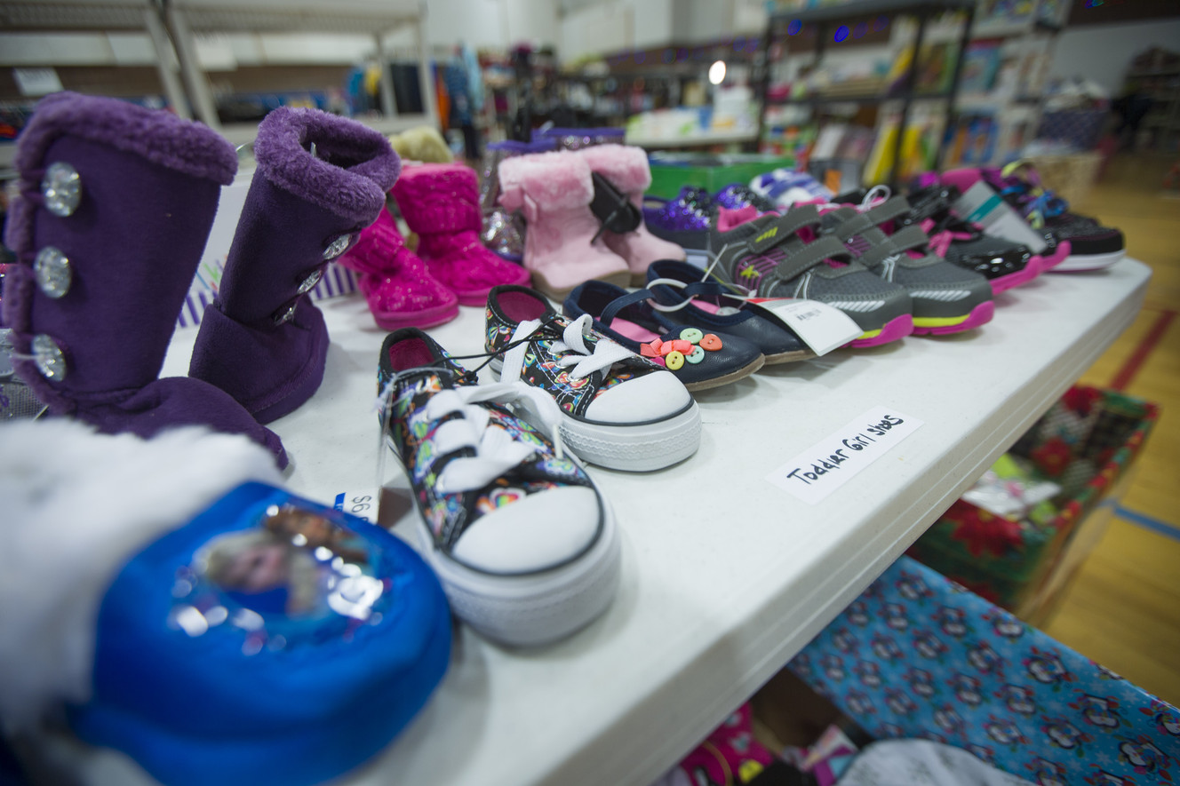 Shoes for young children wait on shelves as the 19th annual Candy Cane Corner holiday store prepares to open in the old Granite High School pool building in South Salt Lake on Monday, Nov. 30, 2015. (Photo: Scott G Winterton, Deseret News)