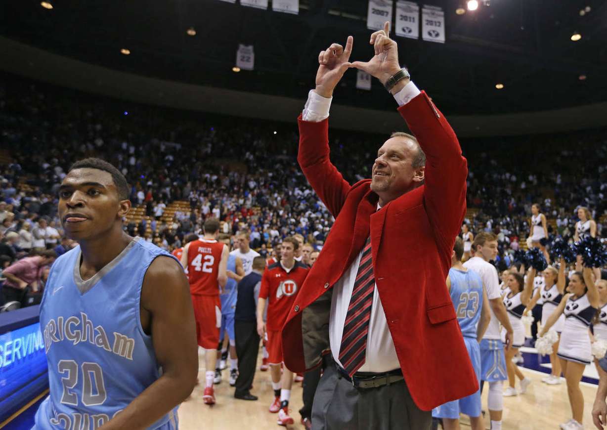 Utah coach Larry Krystkowiak "flashes the U" to a group of University of Utah fans during the Runnin' Utes last trip to the Marriott Center. (Photo: Tom Smart, Deseret News)