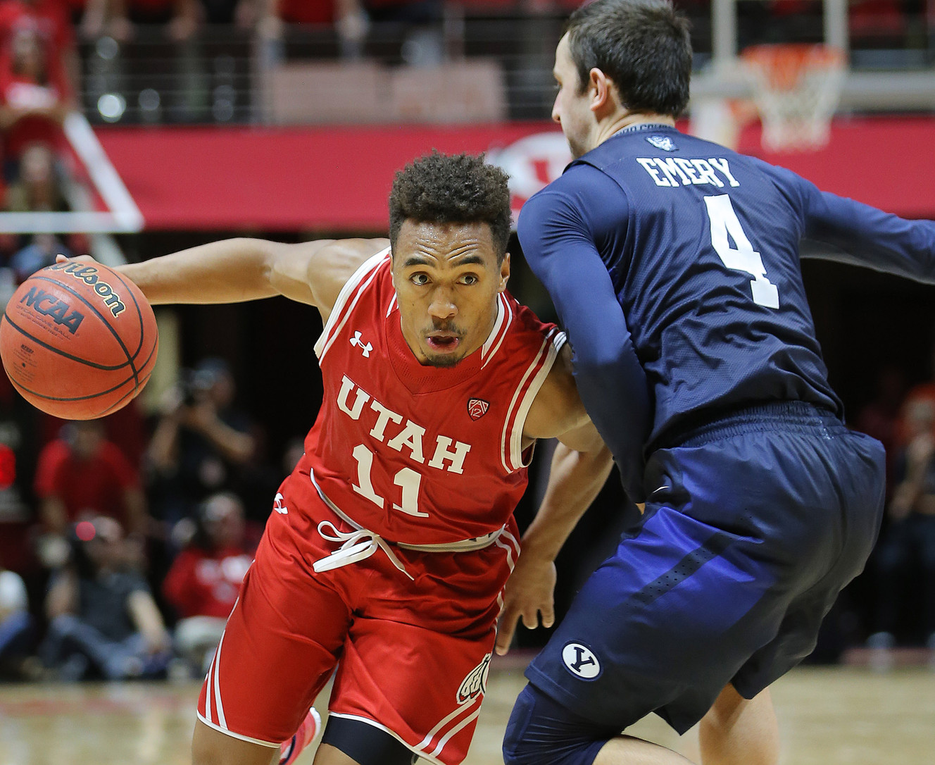 Utah guard Brandon Taylor (11) draws a foul on BYU guard Nick Emery (4) as Utah and BYU play in the Huntsman Center in Salt Lake City, Dec. 2, 2015. Utah won 83-75. (Photo: Scott G Winterton, Deseret News)