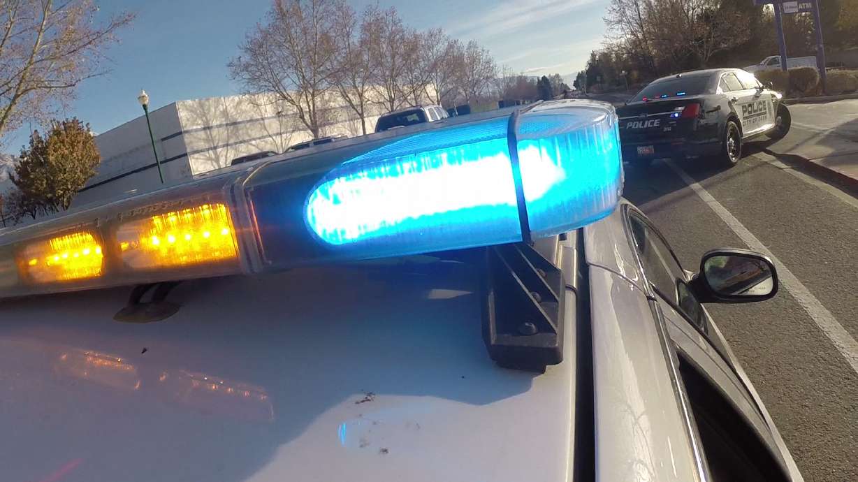 A man was arrested Monday after police say he stole a car with a baby in the back and then tried to hand the child to an off-duty Salt Lake County sheriff's deputy.