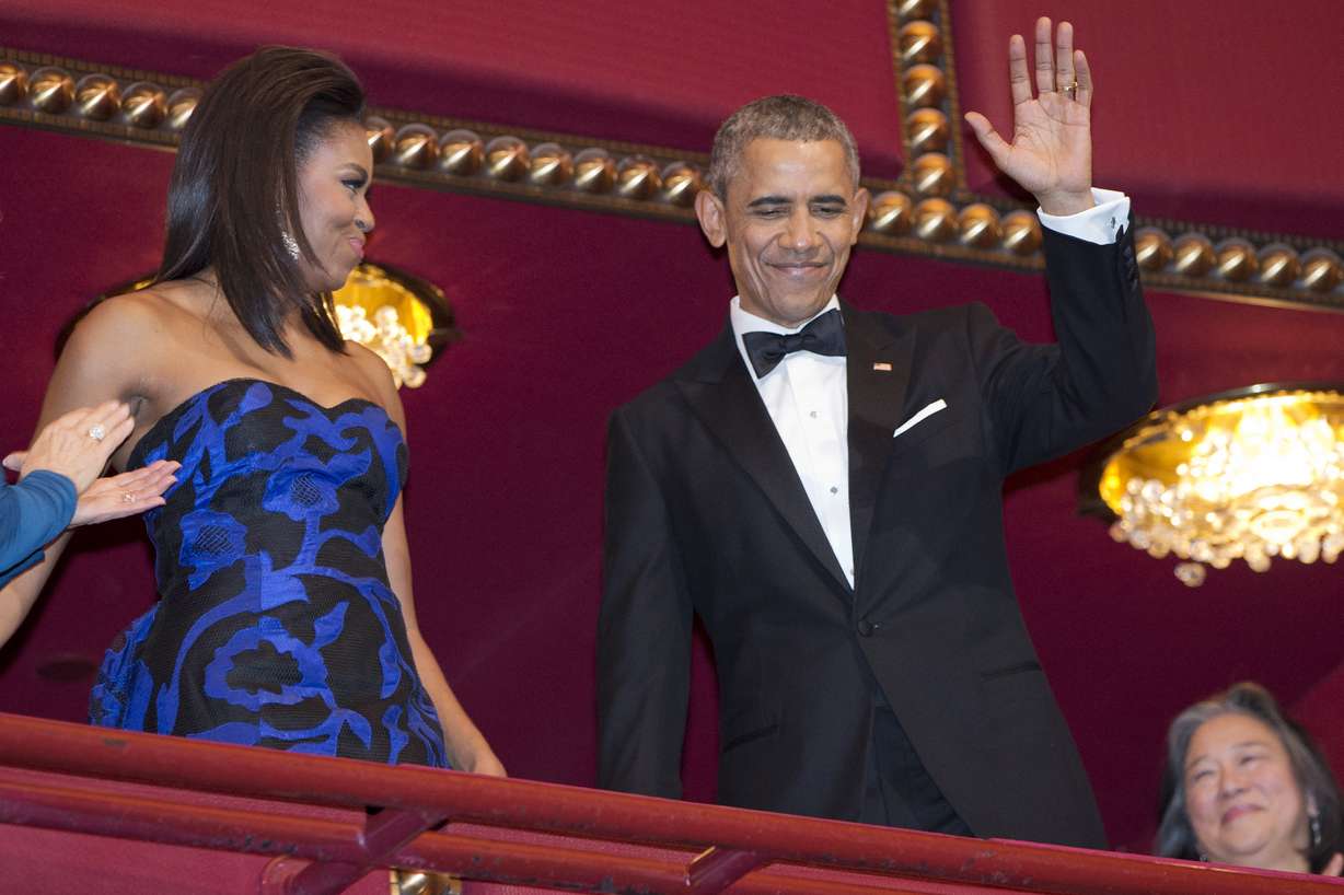 President Barack Obama, with first lady Michelle Obama, waves as they arrive at the 2015 Kennedy Center Honors in Washington, after the President made an address to the nation, Sunday, Dec. 6, 2015. (AP Photo/Jacquelyn Martin)