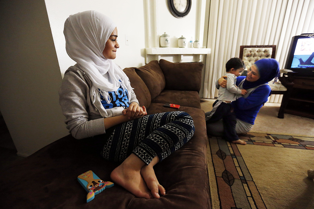 Nour Bilal watches as her mother and brother, Kholoud Abouarida and Zein Bilal, play at home in Millcreek, Tuesday, Nov. 17, 2015. (Photo: Ravell Call, Deseret News)