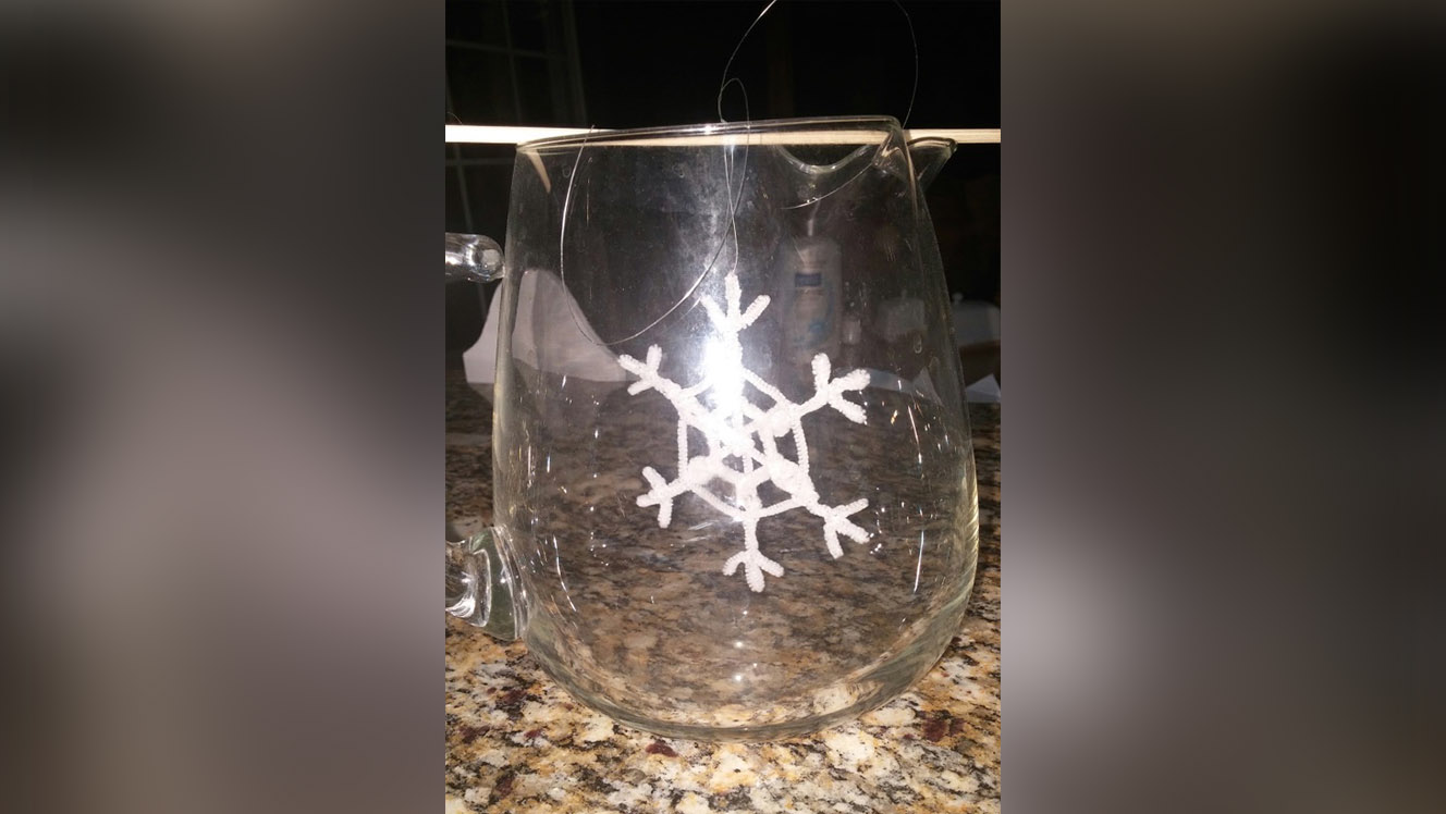 Hang your borax snowflake in the water. Don't disturb the container for eight hours. (Photo: Susan Jeppesen)