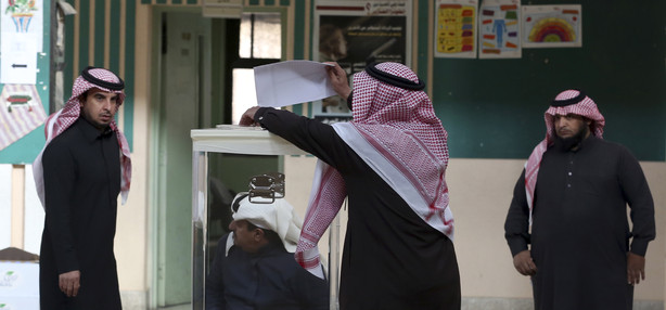 A Saudi man prepares to cast his vote at a polling center during the country's municipal elections in Riyadh, Saudi Arabia, Saturday, Dec. 12, 2015. (AP Photo/Khalid Mohammed)