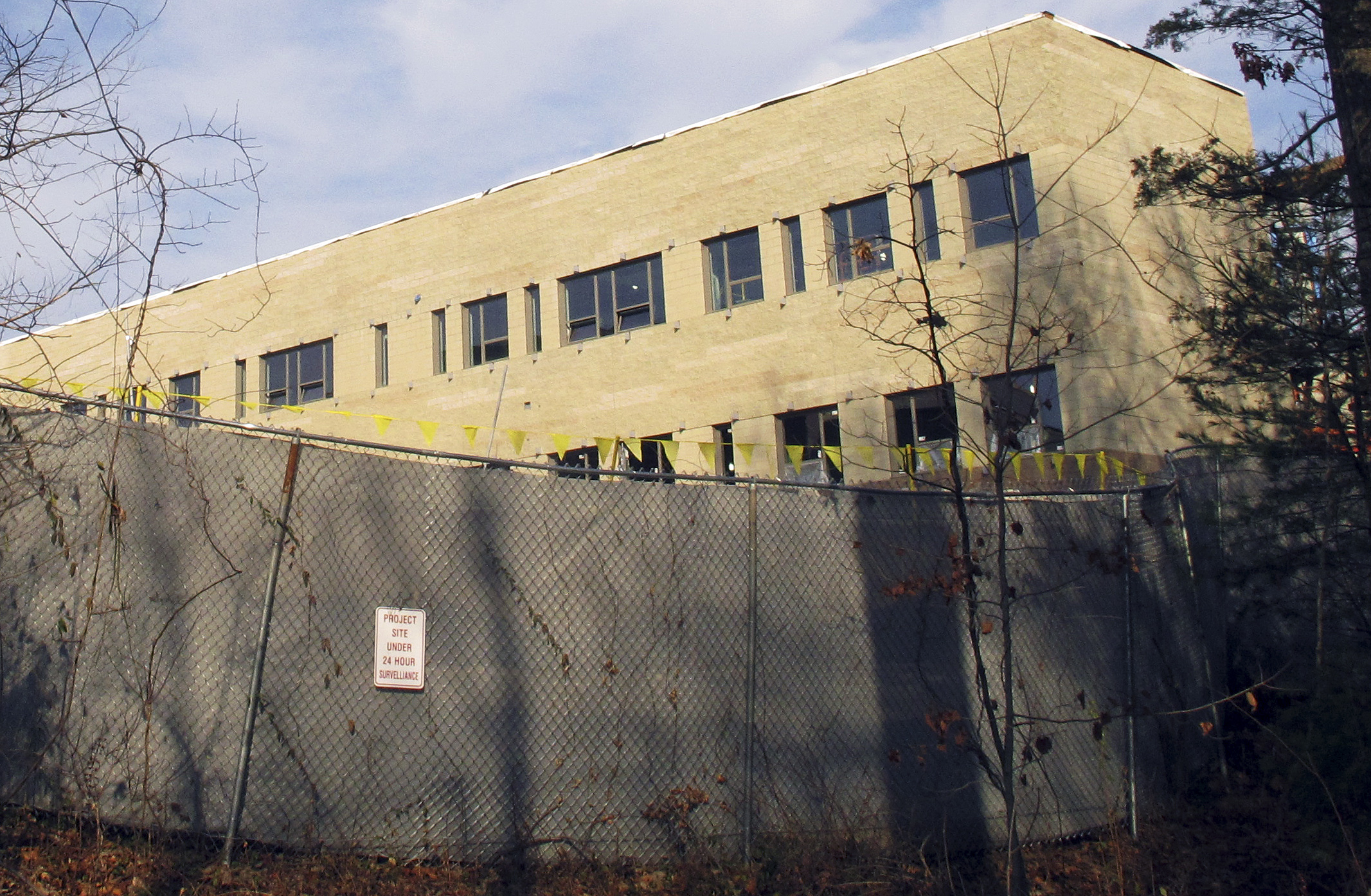 In this Friday, Dec. 11, 2015 photo, construction continues on the new Sandy Hook Elementary School in Newtown, Conn. Monday is the third anniversary of the shooting at Sandy Hook Elementary School that killed 20 first-graders and six educators. The school was torn down after the shooting, and the new one is being built on the same site. (AP Photo/Dave Collins)