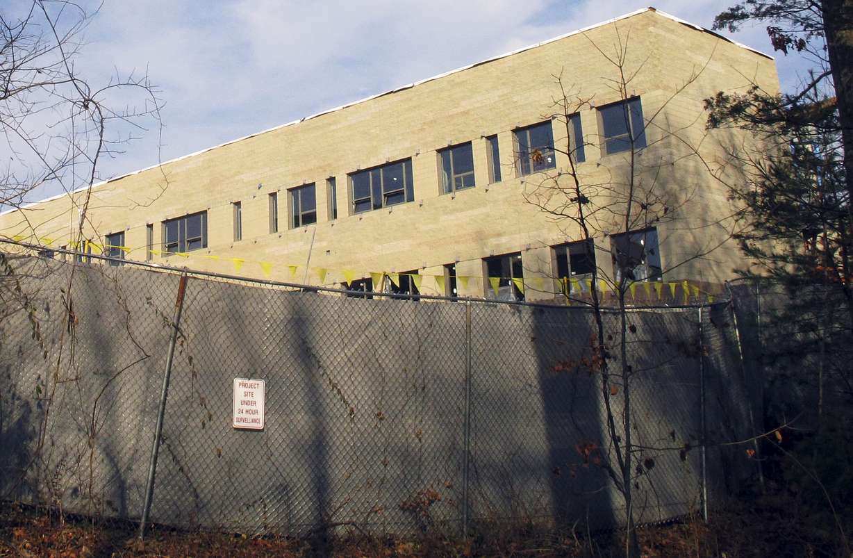 In this Friday, Dec. 11, 2015 photo, construction continues on the new Sandy Hook Elementary School in Newtown, Conn. Monday is the third anniversary of the shooting at Sandy Hook Elementary School that killed 20 first-graders and six educators. The school was torn down after the shooting, and the new one is being built on the same site. (AP Photo/Dave Collins)