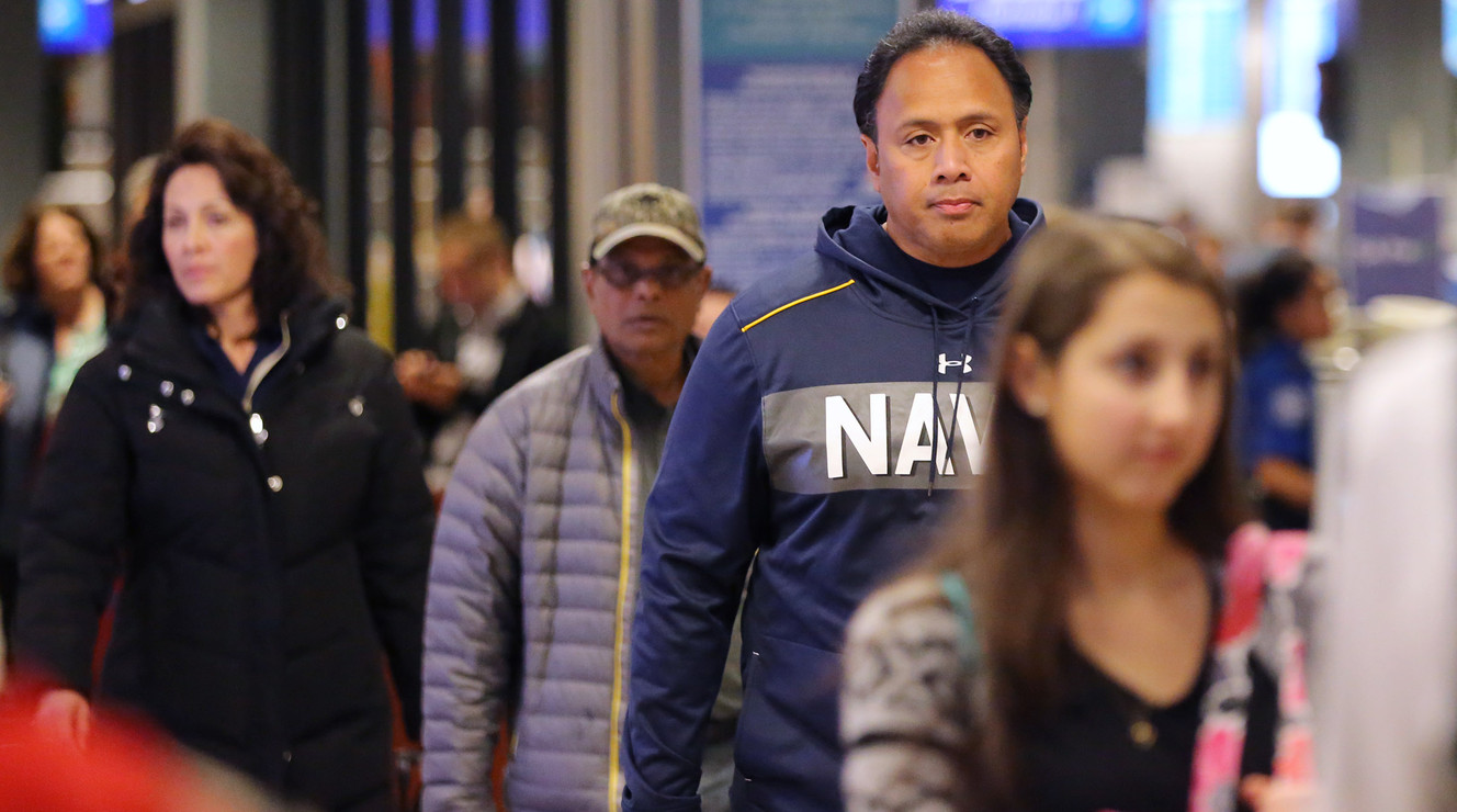 Navy head coach Ken Niumatalolo and his wife Barbara arrived at the airport in Salt Lake City, Dec. 13, 2015. (Photo: Scott G Winterton, Deseret News)