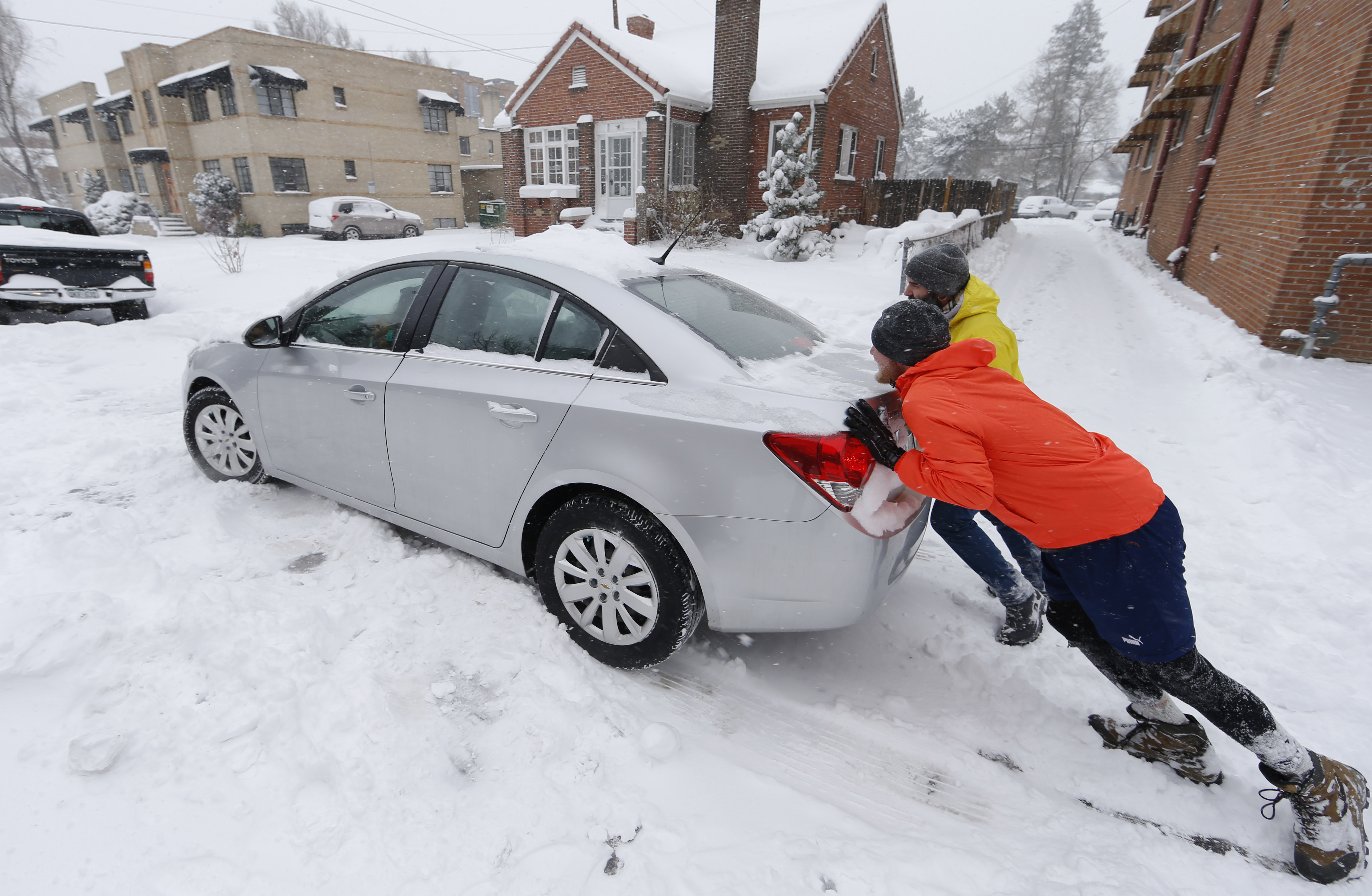 The Latest: Snowplow slips in Colorado during strong storm