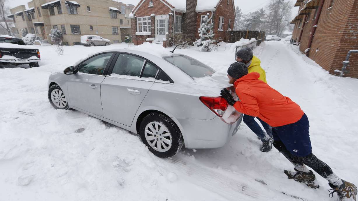 The Latest: Snowplow slips in Colorado during strong storm