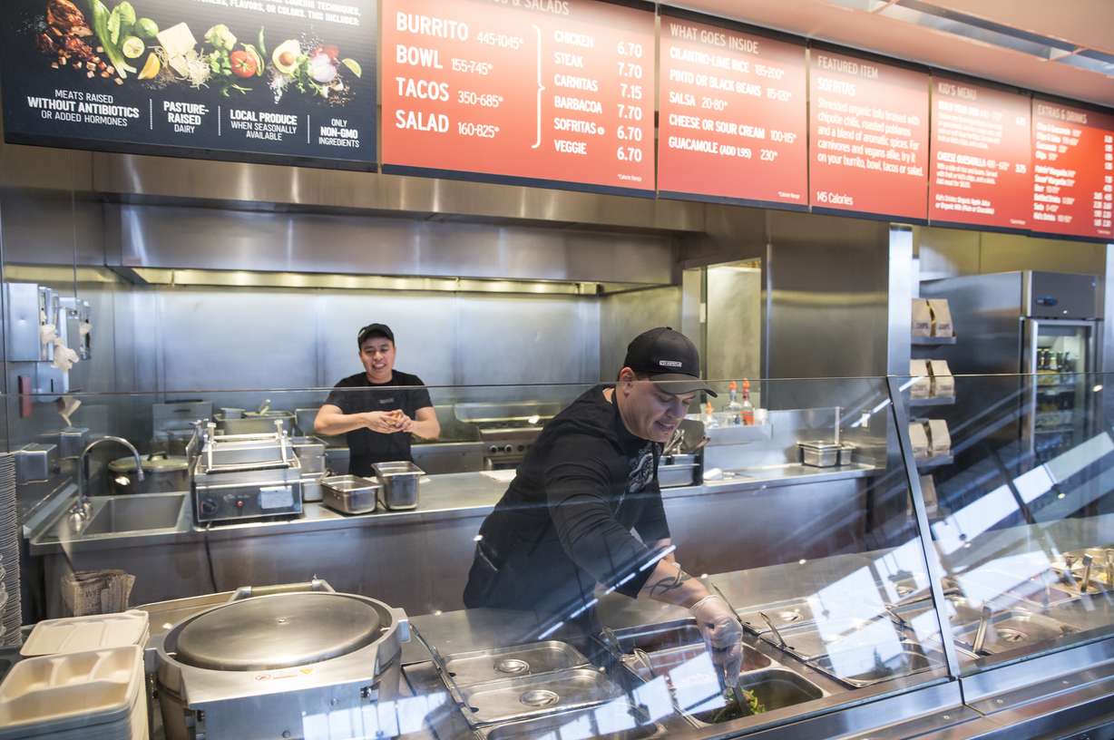 A Chipotle Mexican Grill employee prepares food on Tuesday Dec. 15, 2015, in Seattle. Photo: AP Photo