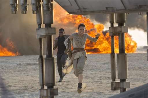 This photo provided by Disney/Lucasfilm shows Daisy Ridley, right, as Rey, and John Boyega as Finn, in a scene from the film, "Star Wars: The Force Awakens," directed by J.J. Abrams. The movie opens in U.S. theaters on Dec. 18, 2015. (David James/Disney/Lucasfilm via AP)
