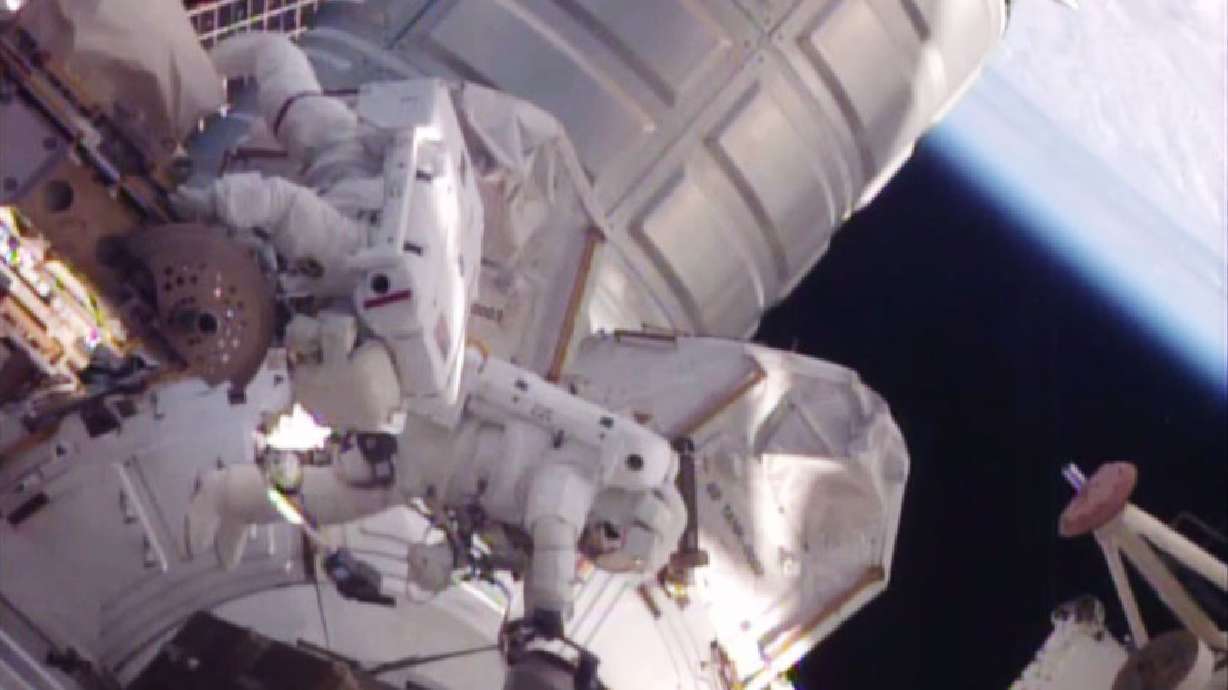 Astronauts help move stalled rail car during spacewalk