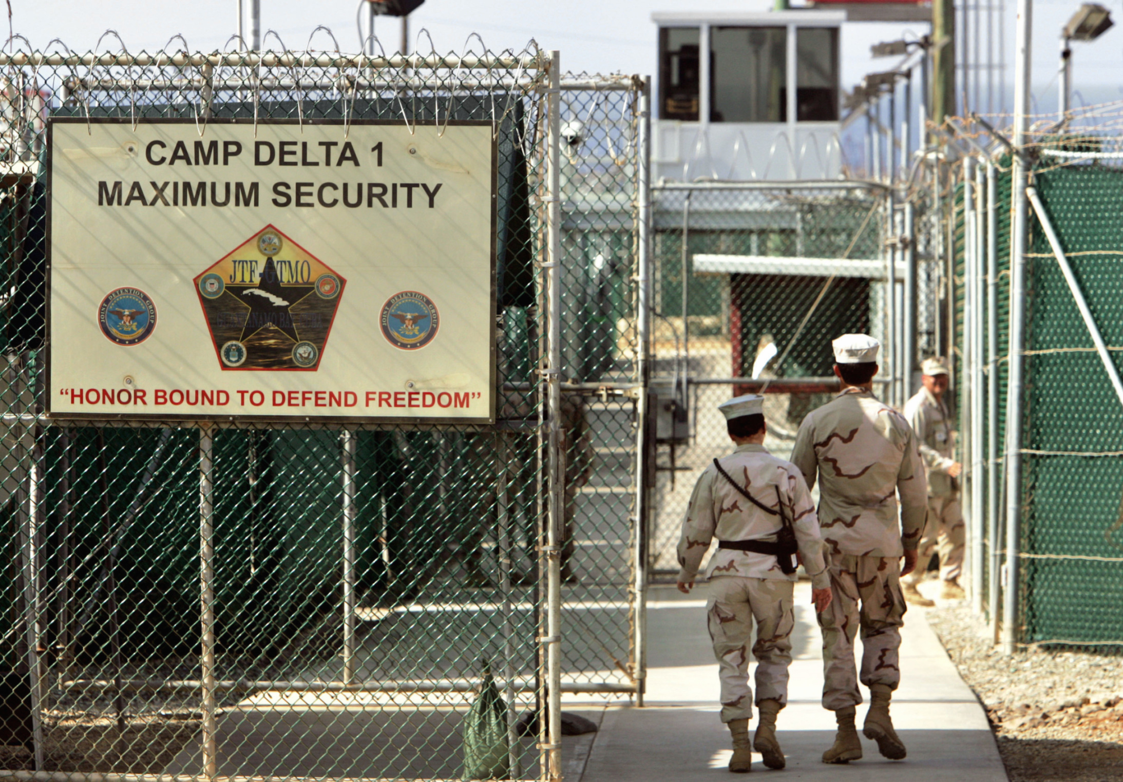 In this June 27, 2006 file photo, U.S. military guards walk within Camp Delta military-run prison, at the Guantanamo Bay U.S. Naval Base, Cuba. Photo: AP Photo