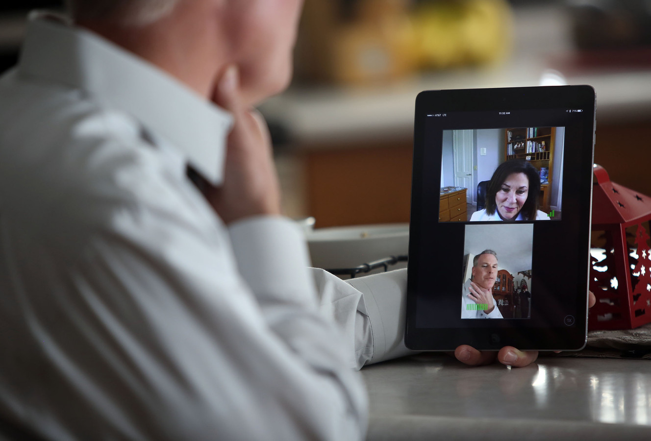 Troy Wood, vice president of business development for MountainStar Healthcare, demonstrates how to use MountainStar Virtual Care with Dr. Deborah Mulligan, M.D., at his co-worker's home in South Jordan on Wednesday, Dec. 30, 2015. (Photo: Kristin Murphy, Deseret News)