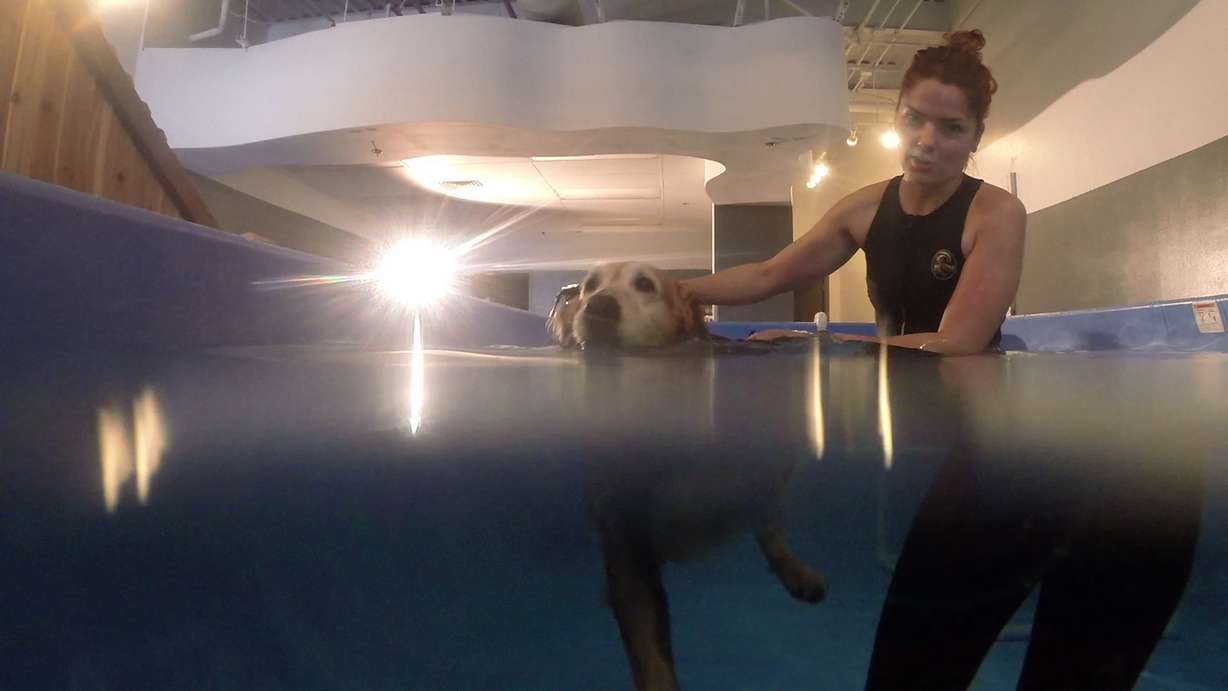 Angela Dirkers helps Miley across the pool. (Photo: Ray Boone)