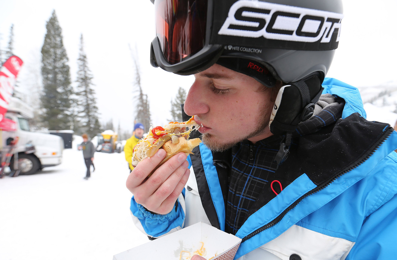 Danny Card eats a brat during the Outdoor Retailer All Mountain Demo Day at Solitude Mountain Resort Wednesday, Jan. 6, 2016. (Photo: Jeffrey D. Allred, Deseret News)