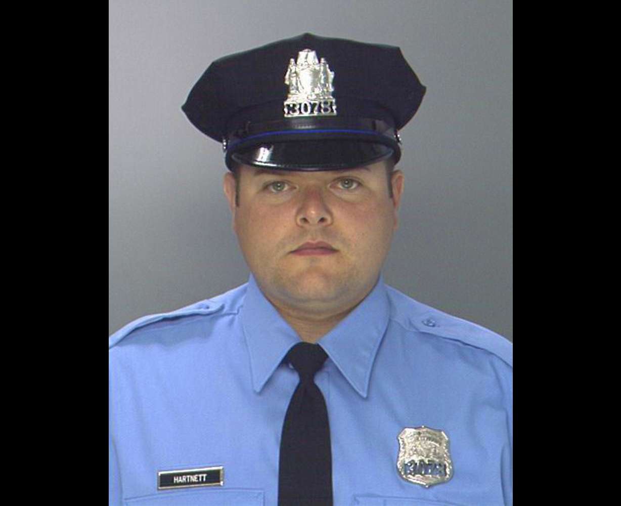 This undated photo provided by the Philadelphia Police Department shows Philadelphia Police Officer Jesse Hartnett. A gunman ambushed the police officer in his marked cruiser at an intersection, striking him multiple times in the arm during a barrage of bullets and fleeing before being apprehended, officials said Friday. (Philadelphia Police Department via AP)