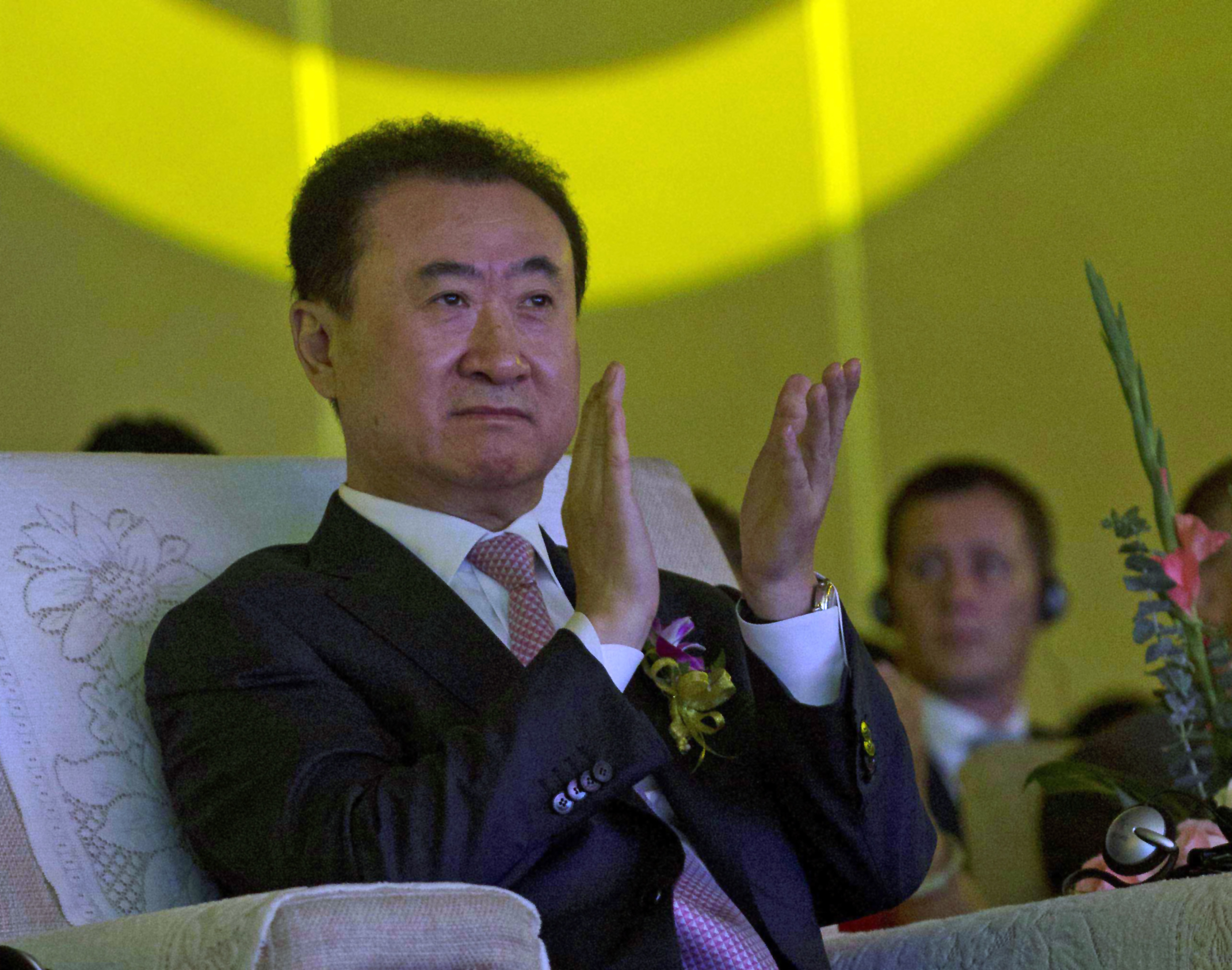 In this June 19, 2013, file photo, Wanda Chairman Wang Jianlin applauds during an event at a hotel in Beijing, China. Photo: AP Photo