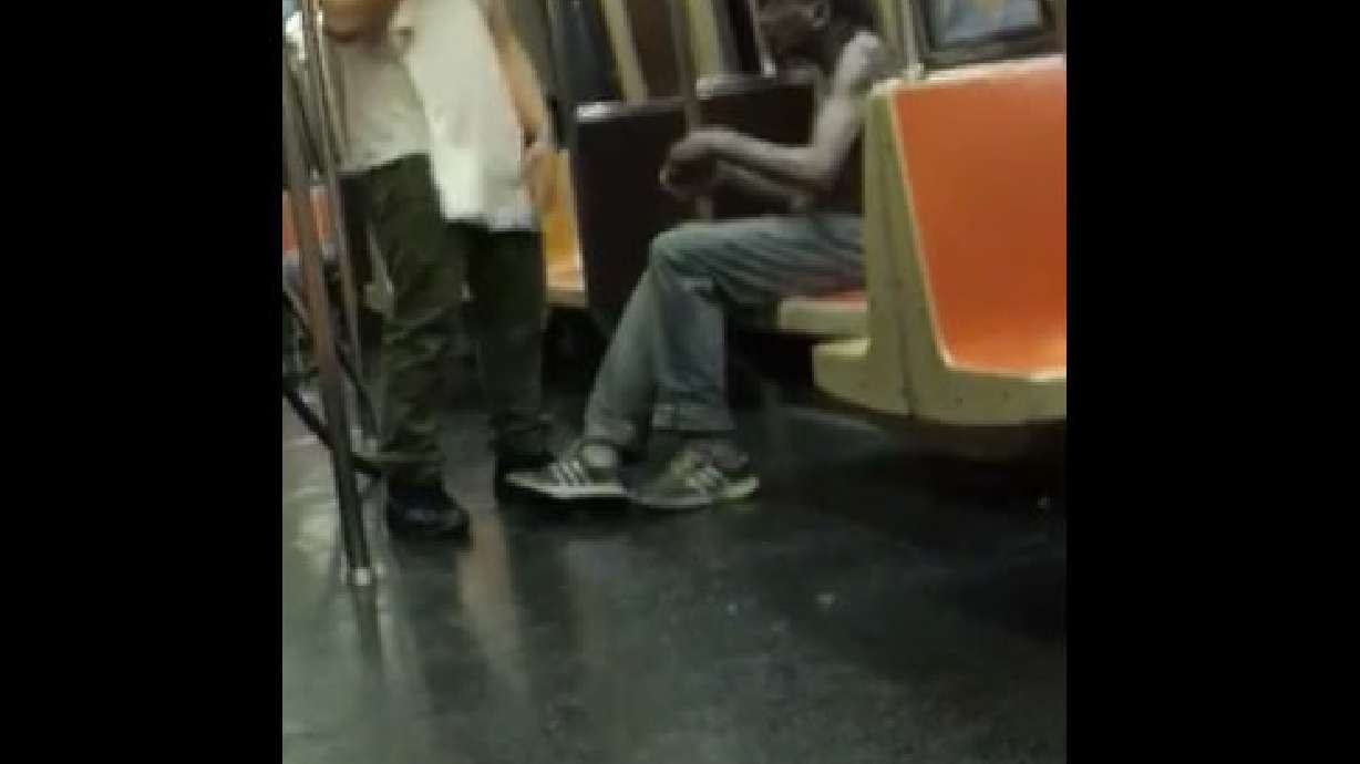 Subway passenger offers homeless man shirt off his back
