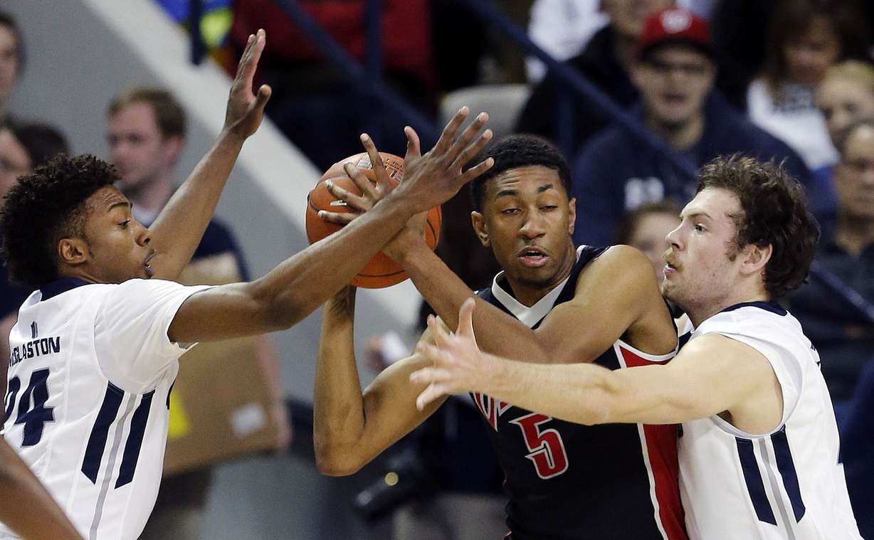 JoJo McGlaston (24) and David Collette (13) of Utah State defend Christian Wood (5) of UNLV during NCAA basketball in Logan, Feb. 24, 2015. (Photo: Ravell Call, Deseret News)