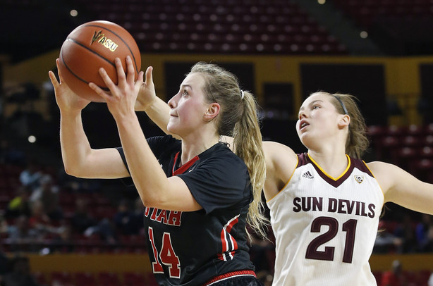 Utah's Paige Crozon (14) goes in to score as she drives past Arizona State's Sophie Brunner (21) during the first half of an NCAA college basketball game Sunday, Jan. 17, 2016, in Tempe, Ariz. (AP Photo/Ross D. Franklin)