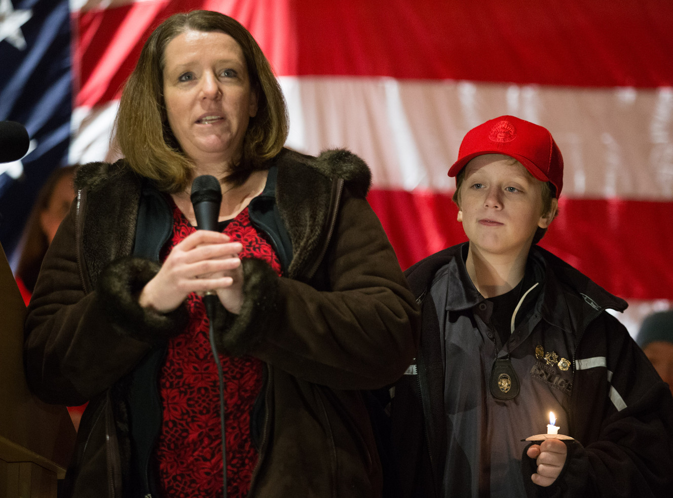 Erika Barney with her son Jack at her side, thanks the hundreds turned out to show respect and support for her husband, Unified Police officer Doug Barney, and fellow officer Jon Richey and his wife, Hannah, at a vigil at a vigil at Holladay City Hall on Wednesday, Jan. 20, 2016. (Photo: Scott G Winterton, Deseret News)