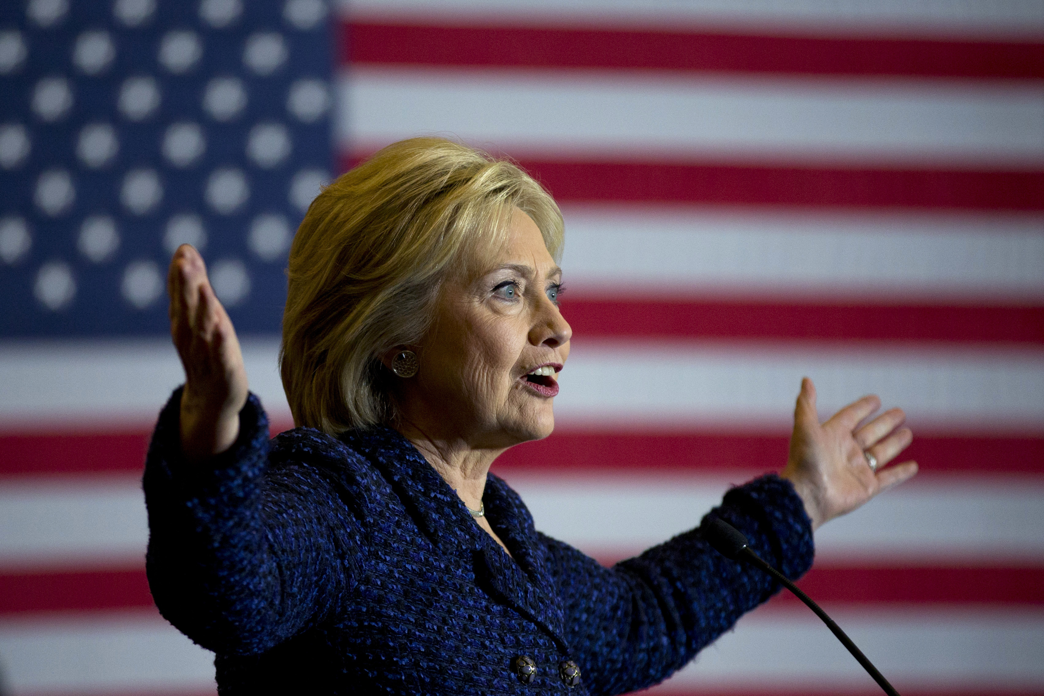 Clinton TV ads hammer guns in NH, shy away in Iowa
