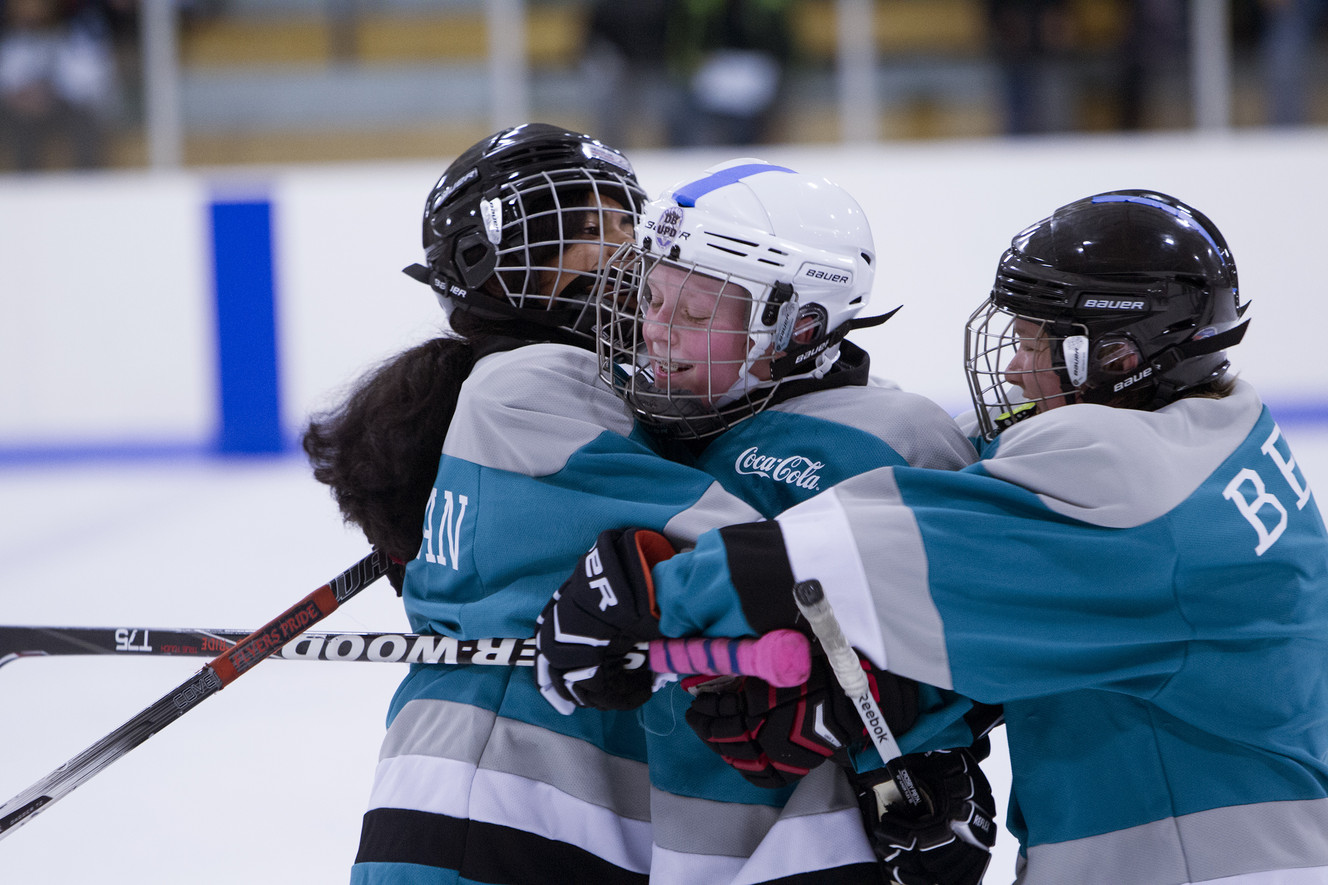 Jack Barney, 13-year-old son of slain police office Doug Barney, is hugged by teammates during a hockey game at the Acord Ice Arena in West Valley City on Saturday, Jan. 23, 2016. Jack's team won the game 4-3. (Photo: Luke Franke, Deseret News)