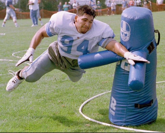 Detroit Lions rookie defensive end Luther Elliss dives for the arms of a practice dummy during a training camp exercise to knock the ball out of a quarterbacks hands, July 22, 1995, in Pontiac, Mich. Elliss was the Lions first round draft pick. (Photo: Duane Burleson, AP Photo)