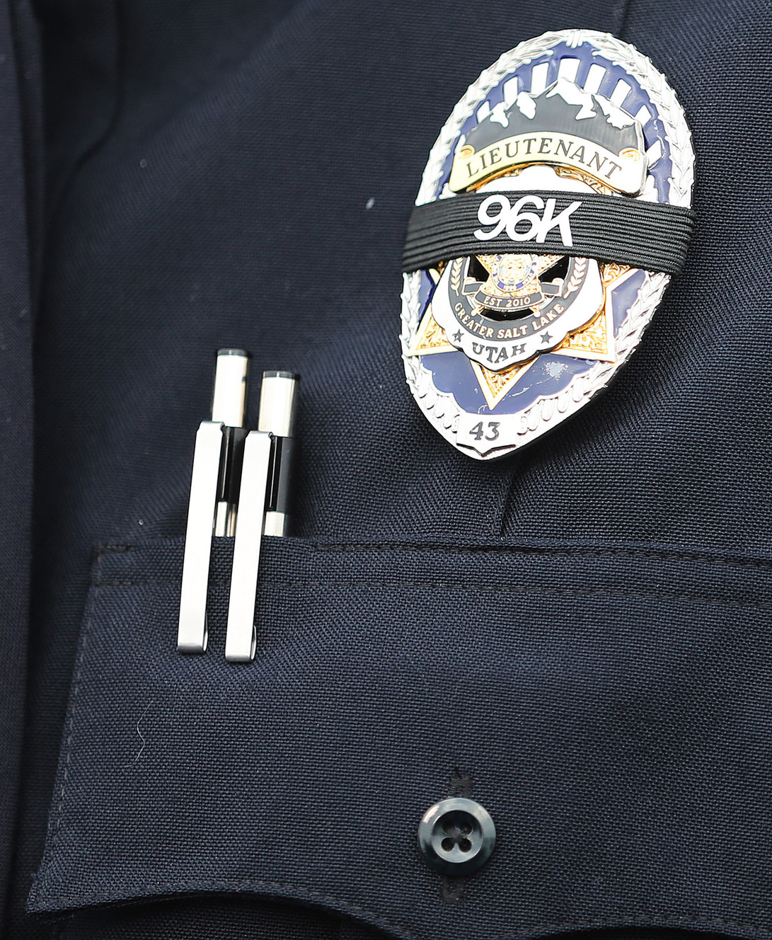 Unified Police Lt. Lex Bell displays slain officer Doug Barney's badge ID number over his badge as law enforcement and community members arrive for Barney's viewing in West Valley City on Sunday, Jan. 24, 2016. (Photo: Scott G Winterton, Deseret News)