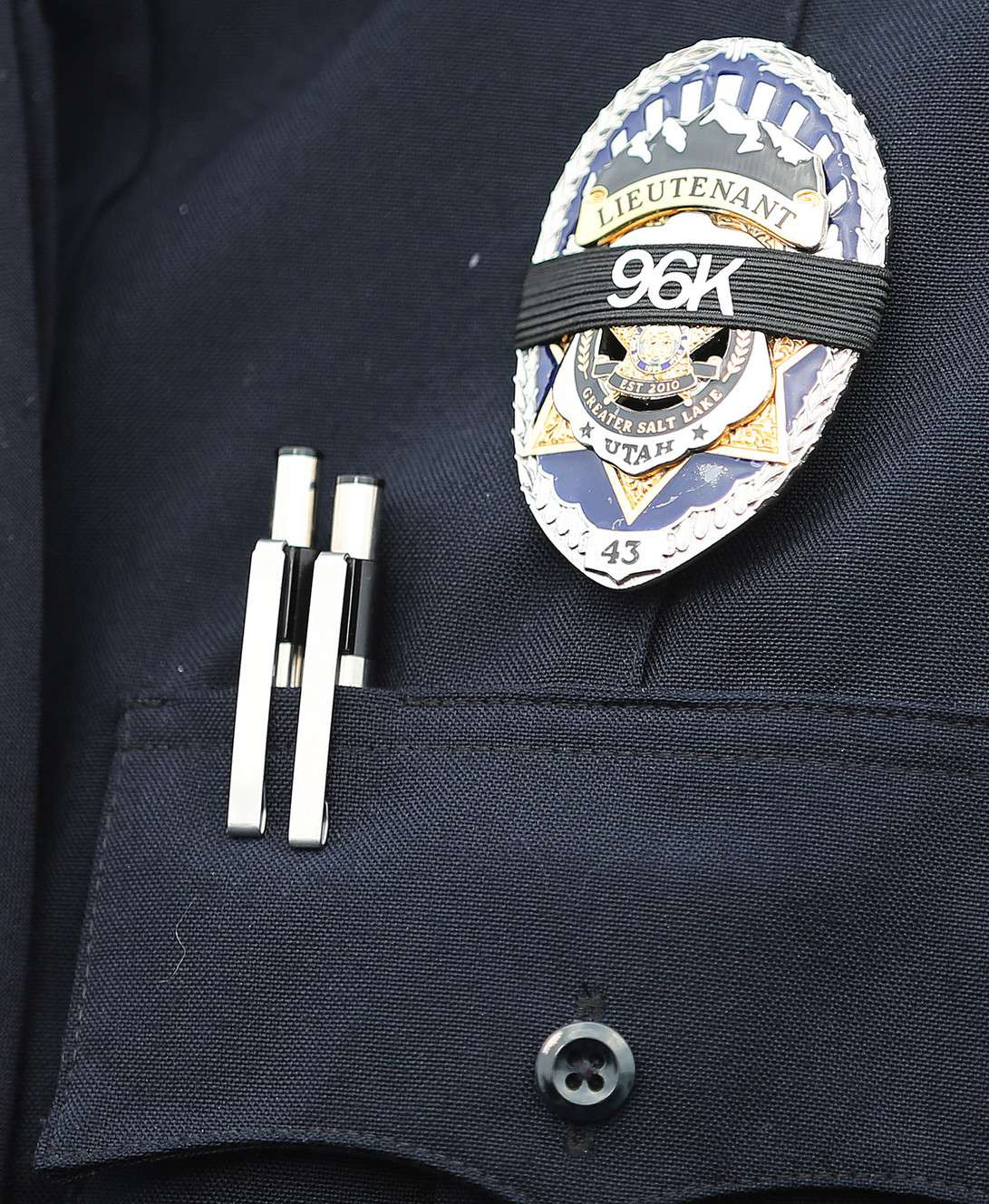 Unified Police Lt. Lex Bell displays slain officer Doug Barney's badge ID number over his badge as law enforcement and community members arrive for Barney's viewing in West Valley City on Sunday, Jan. 24, 2016. (Photo: Scott G Winterton, Deseret News)