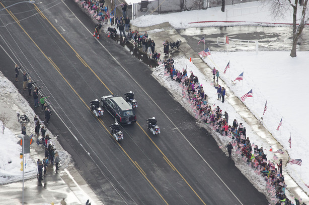 People watch as the funeral procession for Unified police officer Doug Barney makes its way to the Orem City Cemetery, where he will be laid to rest on Monday, Jan. 25, 2016. B(Photo: Luke Franke, Deseret News)
