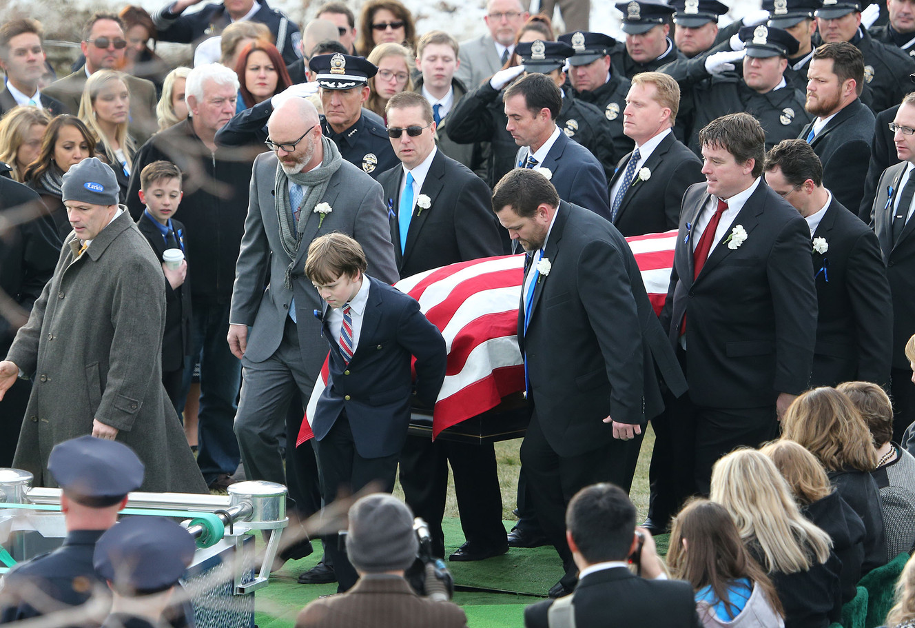 Pallbearers, led by Unified police officer Doug Barney's son Jack, carry Barney's casket to the gravesite at the Orem City Cemetery on Monday, Jan. 25, 2016. (Photo: Tom Smart, Deseret News)