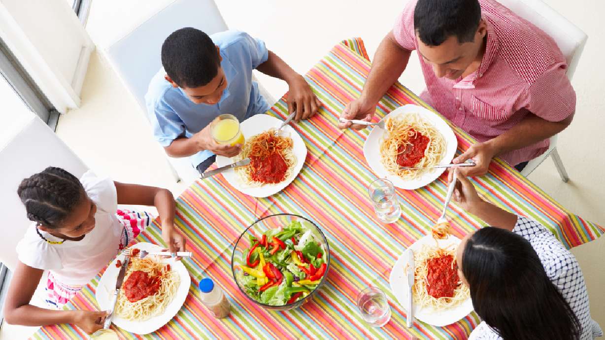 A family is pictured eating a meal together in this undated photo. New data suggests many customers are not about to drop home-cooked meals to come back.