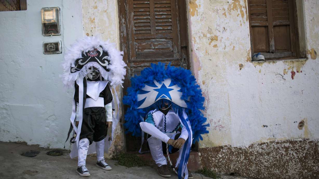 Frowning masks and whips highlight Carnival in Brazil town