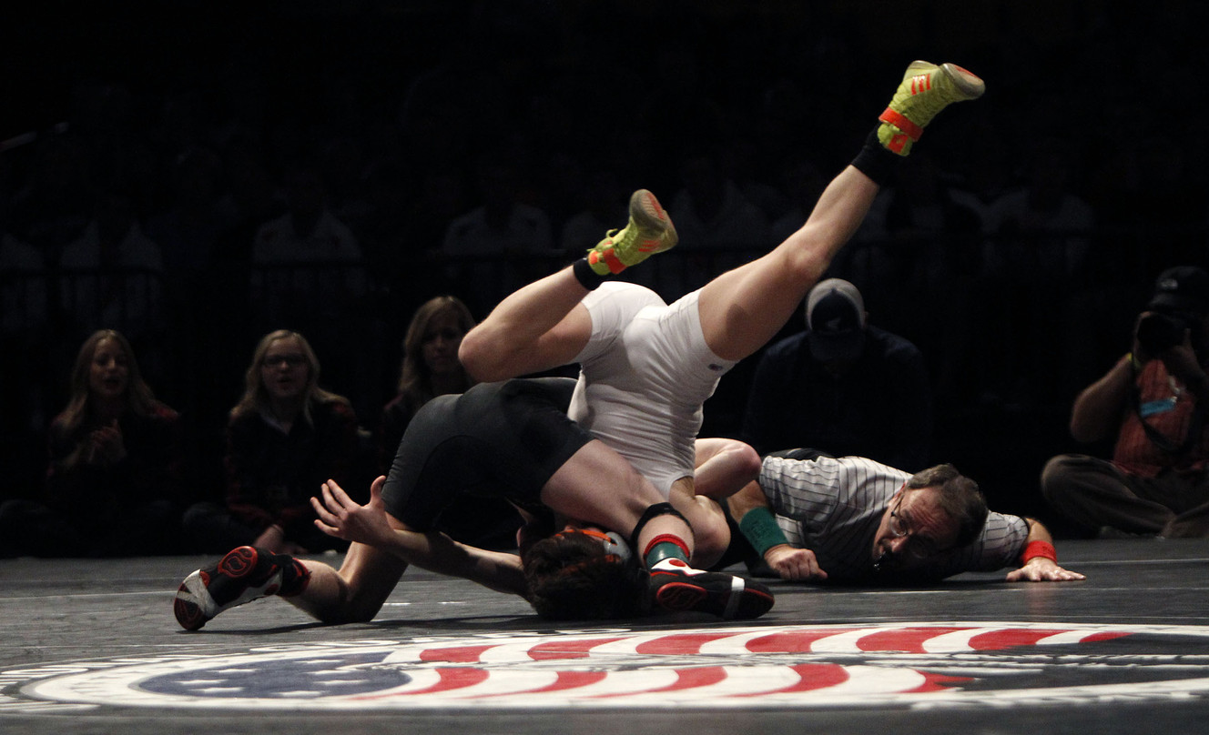 Taylor LaMont of Maple Mountain and Trevor Lowe of Mountain Crest compete at the 4A State Wrestling Championships at UVU in Orem, Feb. 12, 2015. (Photo: Chelsey Allder, Deseret News)
