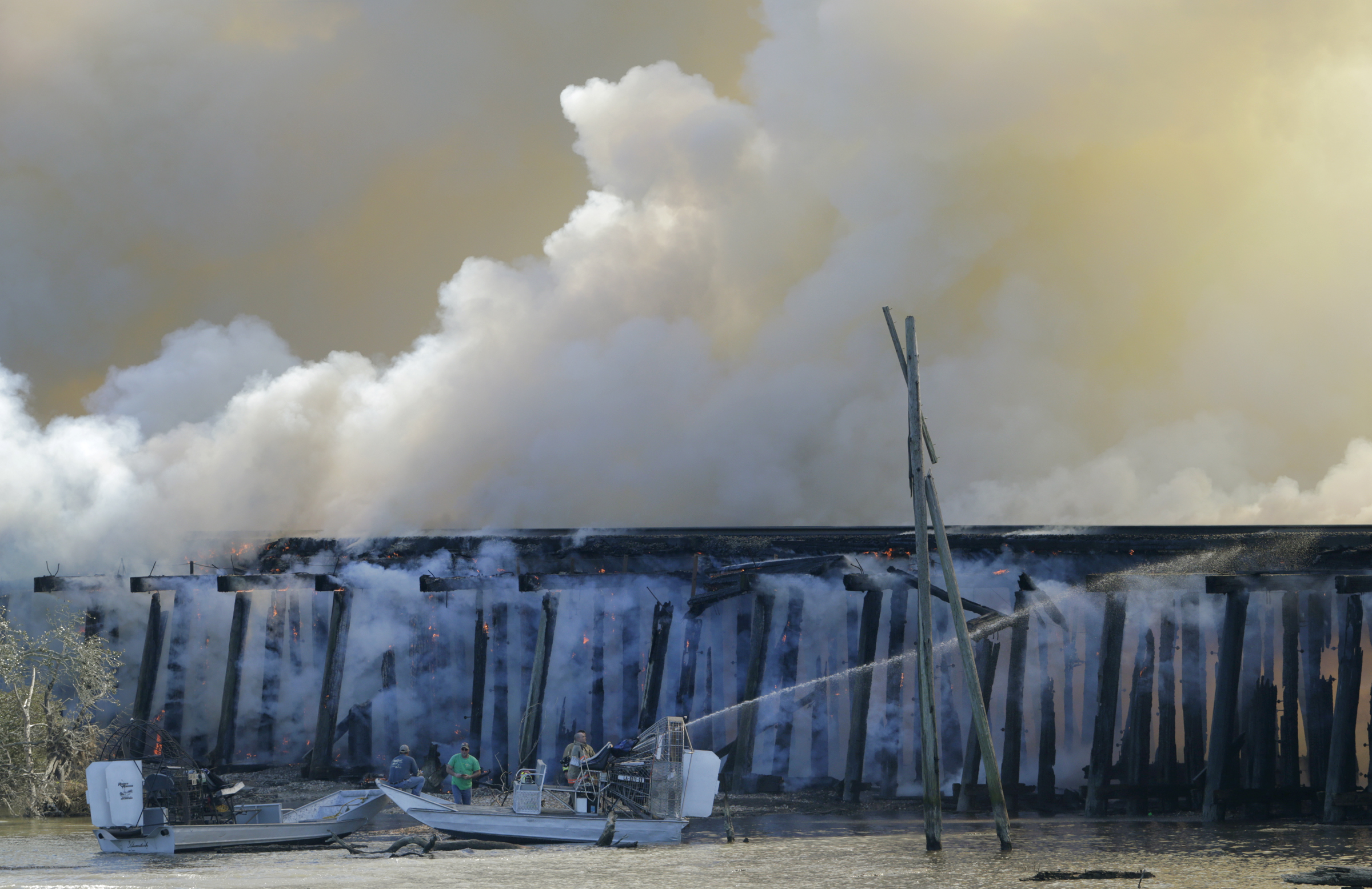 The Latest: Rail bridge fire out, Amtrak service disrupted