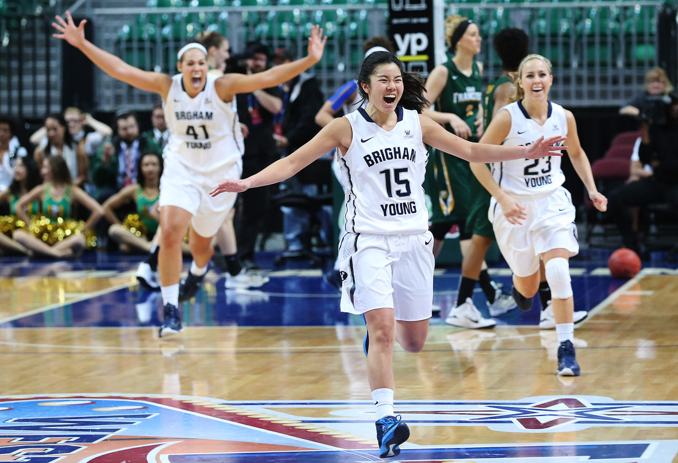 BYU guard Kylie Maeda (15) and the BYU players celebrate their win over the San Francisco during the West Coast Conference Tournament championship game in Las Vegas, Mar 10, 2015. BYU won 76-65. (Photo: Jeffrey D. Allred, Deseret News)